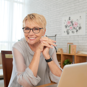 Older lady sat at her kitchen table working her second job from home